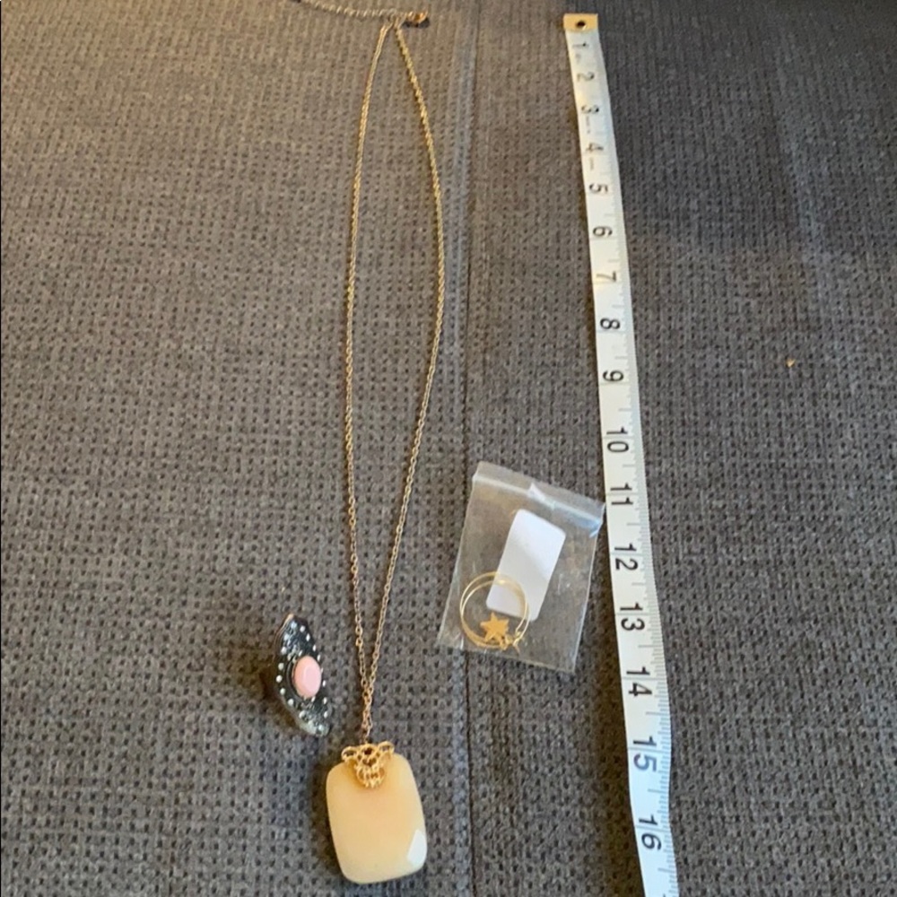 Necklace, star earrings, pink statement ring.
